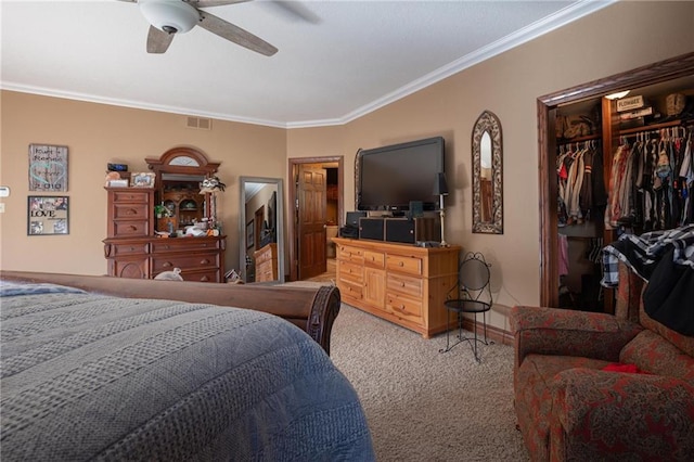 carpeted bedroom with crown molding, a closet, and ceiling fan