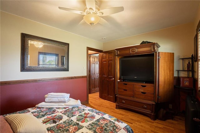 bedroom with ceiling fan and light wood-type flooring