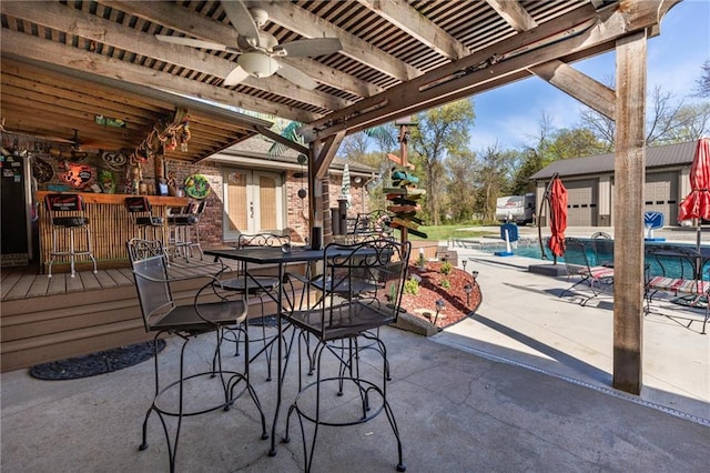 view of patio / terrace with an outdoor bar and ceiling fan