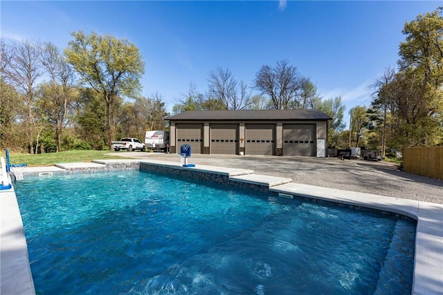 view of swimming pool featuring an outbuilding