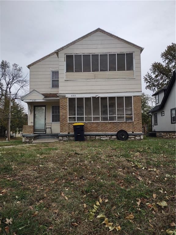 rear view of house with a yard