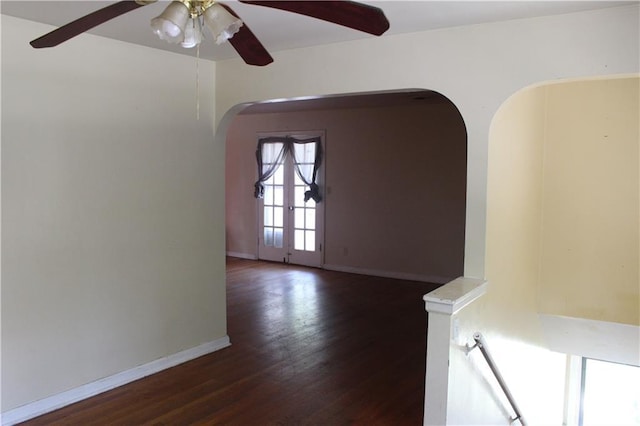 empty room with ceiling fan and dark hardwood / wood-style flooring