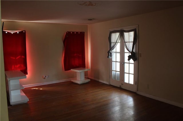 spare room with a healthy amount of sunlight and dark hardwood / wood-style flooring