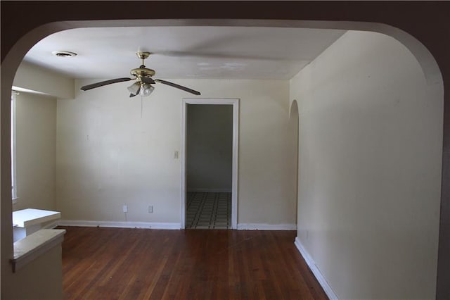 unfurnished room with dark hardwood / wood-style floors and ceiling fan