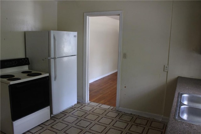 kitchen with electric range oven and sink