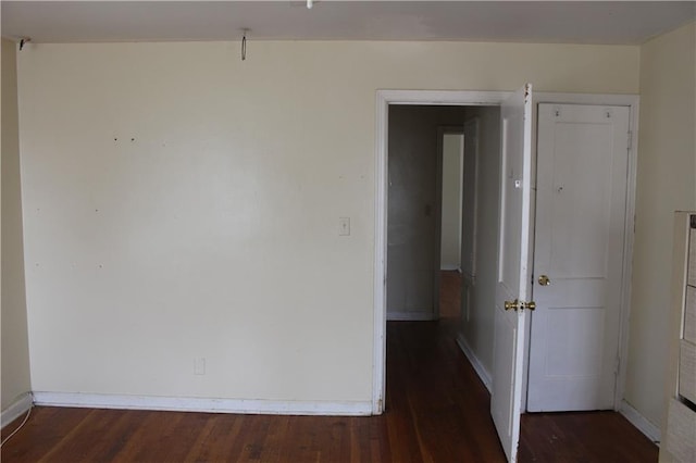 empty room featuring dark wood-type flooring