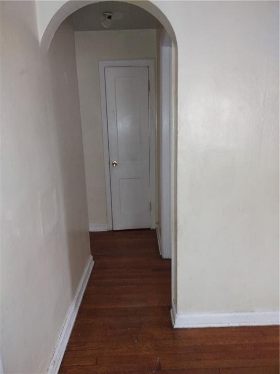 hallway with dark hardwood / wood-style flooring