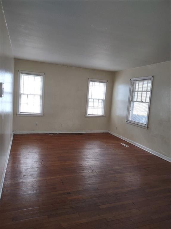 empty room featuring dark hardwood / wood-style flooring