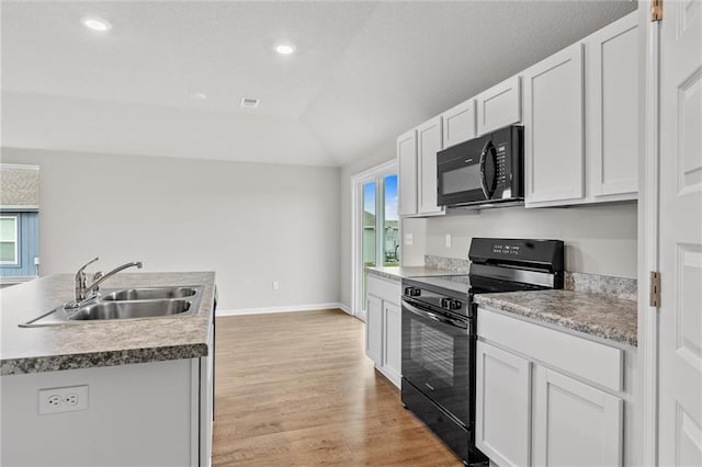 kitchen featuring black appliances, light wood-type flooring, white cabinetry, and sink