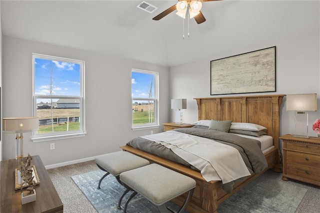 carpeted bedroom with multiple windows and ceiling fan