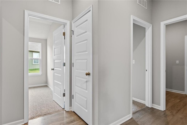 corridor with light hardwood / wood-style floors