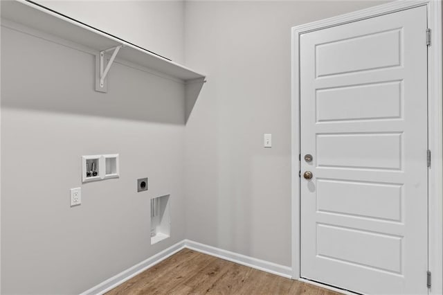 clothes washing area with hookup for an electric dryer, hookup for a washing machine, and hardwood / wood-style flooring