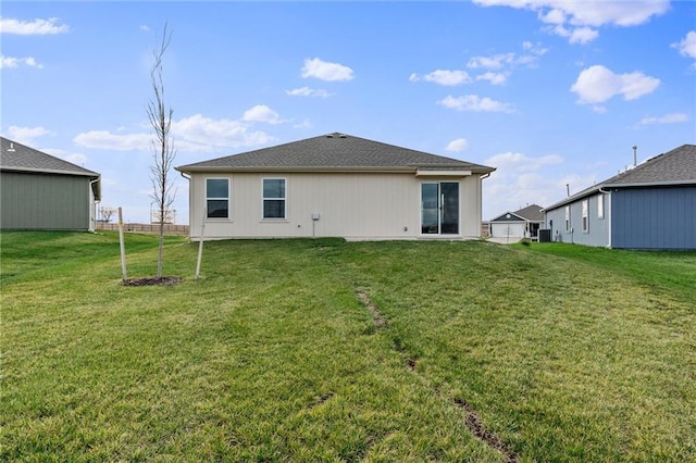 rear view of property with a lawn