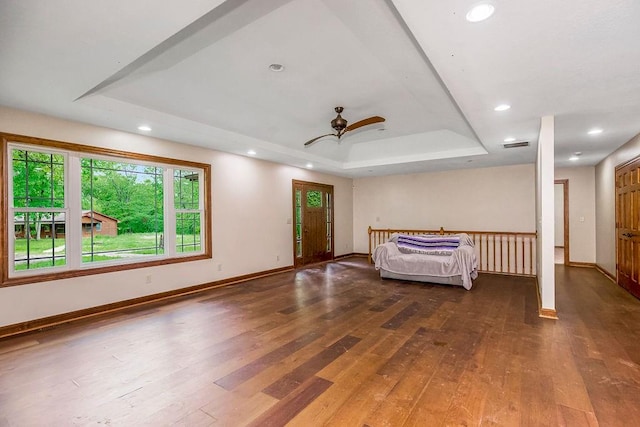 interior space featuring a tray ceiling, ceiling fan, and hardwood / wood-style floors