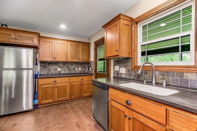 kitchen featuring backsplash, appliances with stainless steel finishes, sink, and dark hardwood / wood-style floors