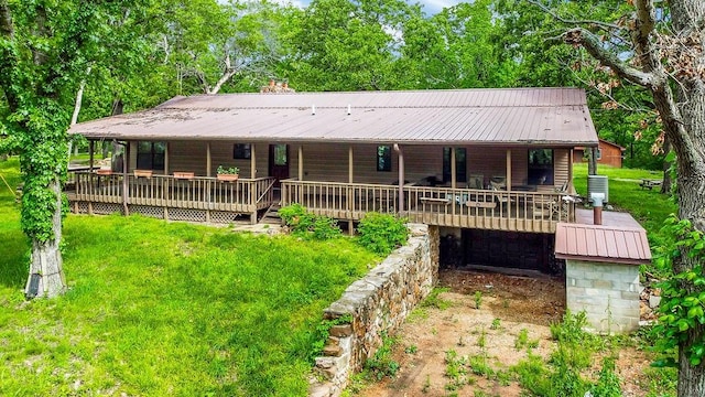 exterior space featuring a front yard and a wooden deck