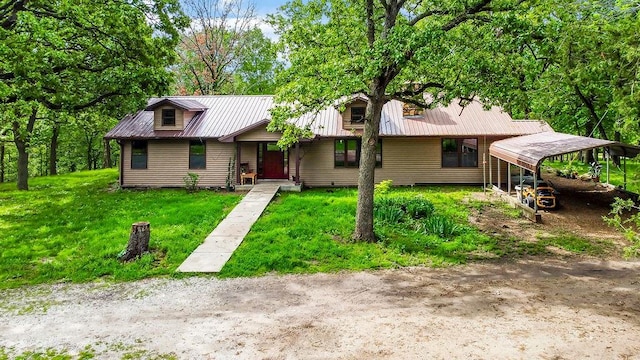 ranch-style home featuring a front yard and a carport