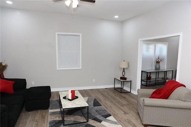 living room with wood-type flooring and ceiling fan