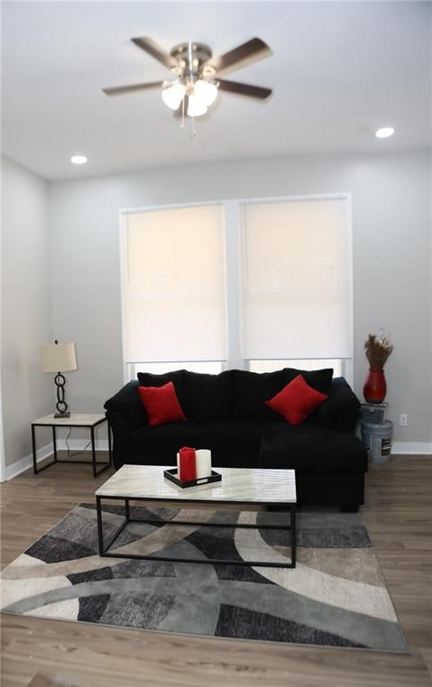 living room featuring dark hardwood / wood-style floors and ceiling fan