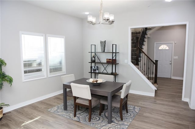 dining room featuring wood-type flooring and a chandelier