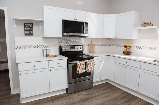 kitchen featuring appliances with stainless steel finishes, dark hardwood / wood-style floors, tasteful backsplash, and white cabinetry