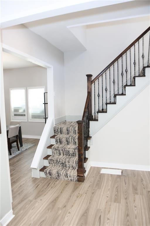 stairway with light wood-type flooring