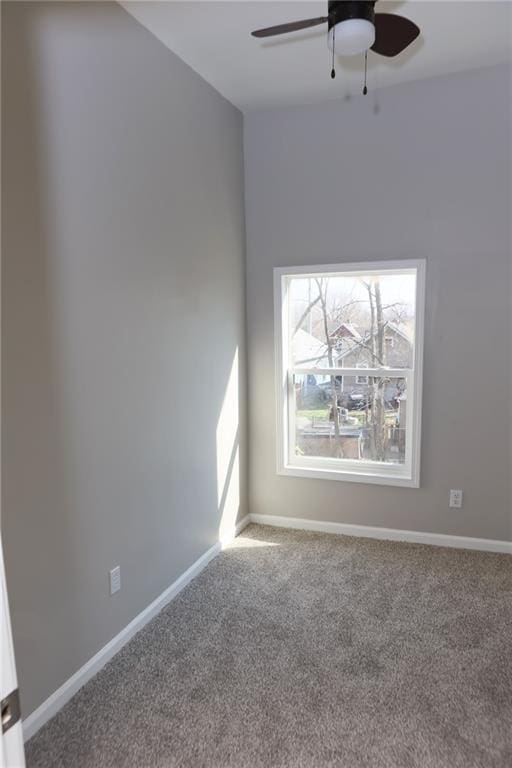 empty room with ceiling fan and carpet floors