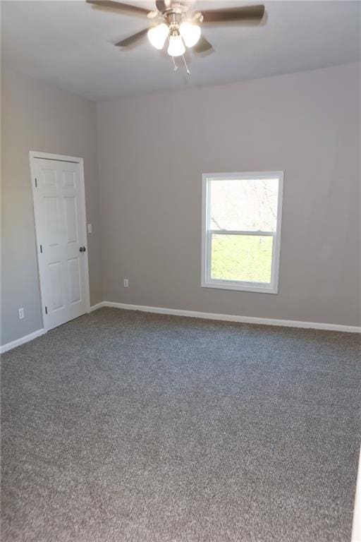 carpeted spare room featuring ceiling fan