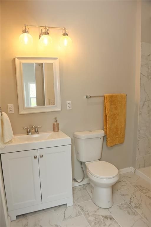 bathroom with tile floors, vanity, and toilet