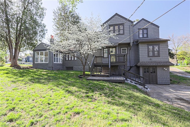 view of front of property with a deck and a front yard