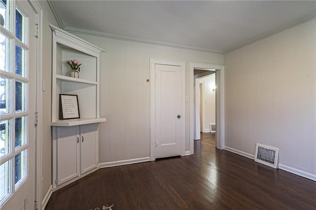 interior space with dark hardwood / wood-style flooring and ornamental molding