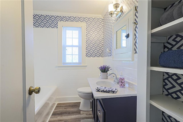 bathroom featuring toilet, hardwood / wood-style floors, vanity, and crown molding