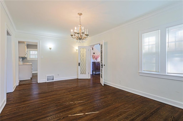 spare room featuring crown molding, an inviting chandelier, and dark hardwood / wood-style flooring