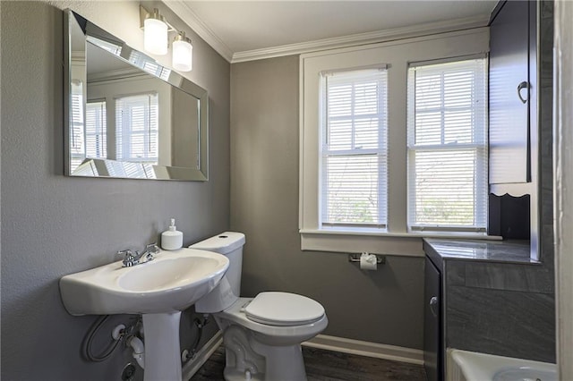 bathroom featuring plenty of natural light, ornamental molding, toilet, and wood-type flooring