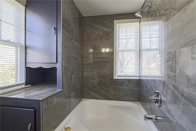 bathroom featuring tiled shower / bath and a healthy amount of sunlight