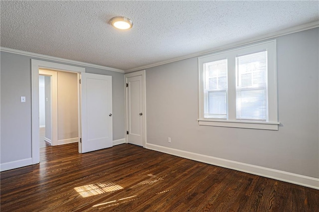 spare room featuring a textured ceiling and dark hardwood / wood-style flooring