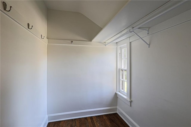 spacious closet featuring dark wood-type flooring and vaulted ceiling