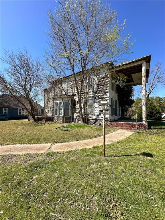 rear view of property featuring a yard