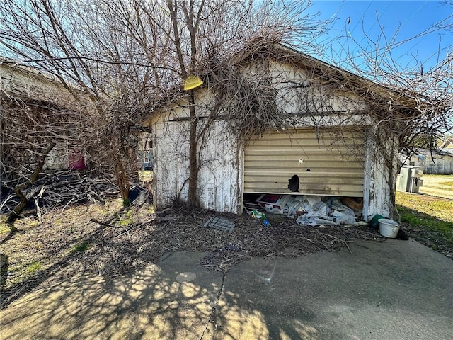 view of property exterior with an outdoor structure and a garage