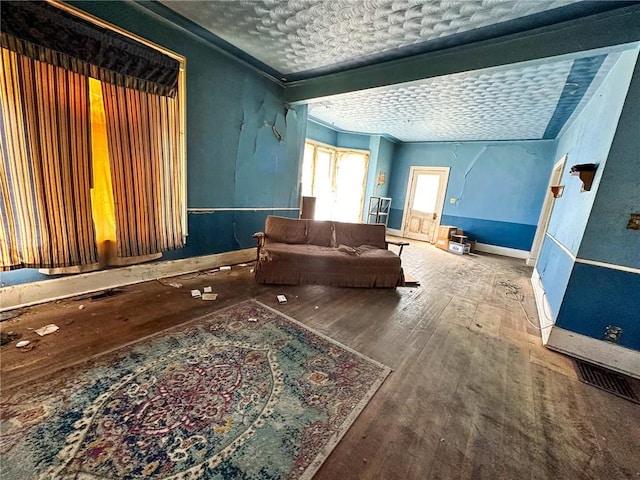 living area with hardwood / wood-style floors and a textured ceiling