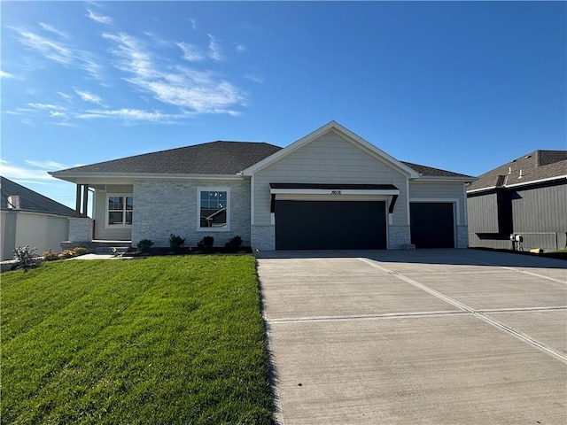 view of front of home with a front yard and a garage