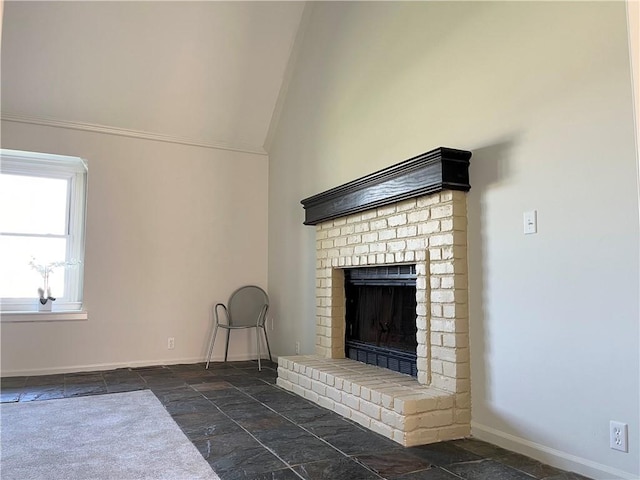 15523A W 303rd St, Paola, KS 66071 - unfurnished living room featuring dark tile floors, a brick fireplace, and lofted ceiling