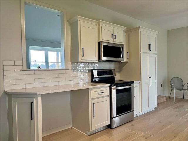 15523A W 303rd St, Paola, KS 66071 - kitchen with appliances with stainless steel finishes, light hardwood / wood-style flooring, backsplash, and white cabinets