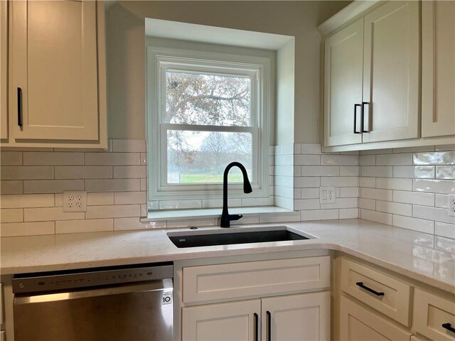 15523A W 303rd St, Paola, KS 66071 - kitchen featuring white cabinets, sink, dishwasher, backsplash, and light stone countertops