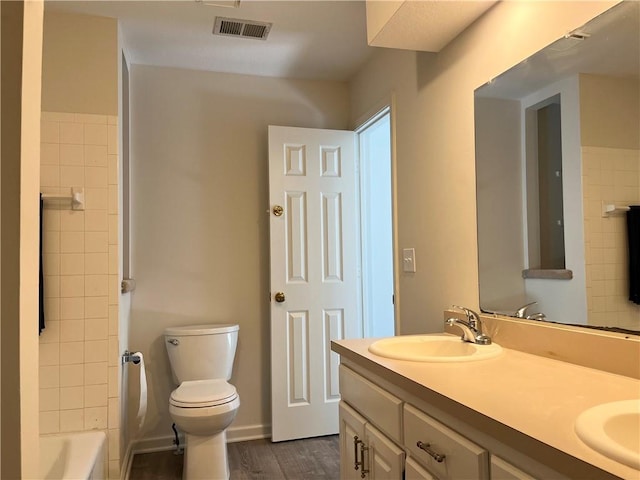 15523A W 303rd St, Paola, KS 66071 - full bathroom featuring wood-type flooring, toilet, tiled shower / bath combo, and dual vanity