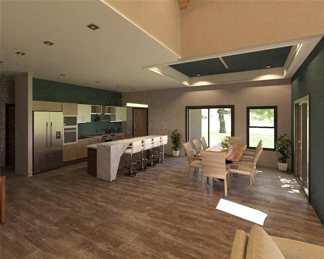 dining area featuring a high ceiling and dark hardwood / wood-style floors