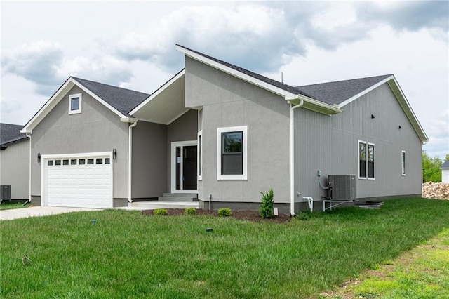 149 S Linn Valley Dr, Linn Valley, KS 66040 - view of front of home with an attached garage, cooling unit, concrete driveway, and a front lawn