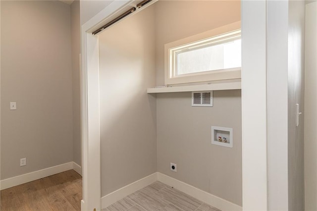 149 S Linn Valley Dr, Linn Valley, KS 66040 - laundry area with washer hookup, baseboards, light wood-style floors, and electric dryer hookup
