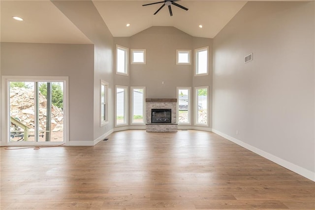 149 S Linn Valley Dr, Linn Valley, KS 66040 - unfurnished living room with wood-type flooring, a ceiling fan, healthy amount of natural light, a fireplace, and recessed lighting