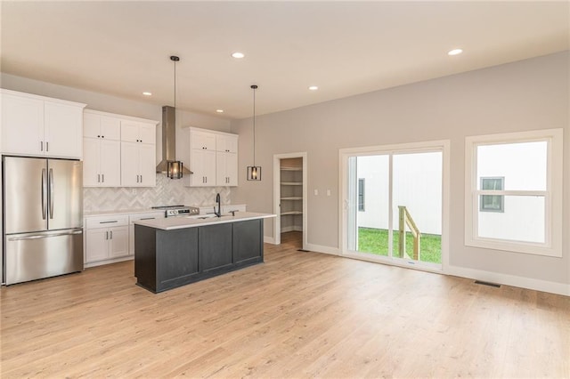 149 S Linn Valley Dr, Linn Valley, KS 66040 - kitchen featuring stainless steel fridge, wall chimney range hood, a sink, recessed lighting, and decorative backsplash